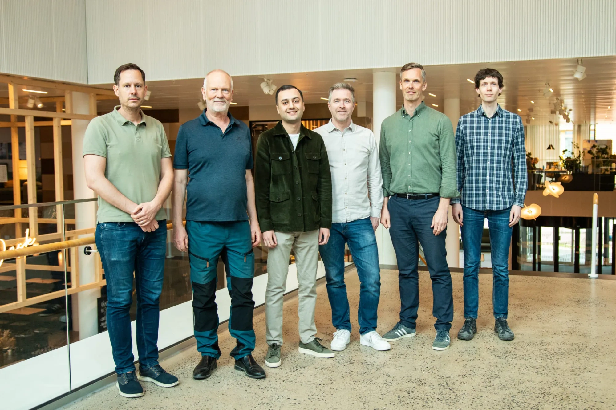 Team Xense - six people standing next to each other in an office environment.